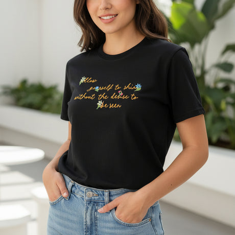 Black tshirt with colorful text worn outdoors