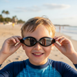 Boy holding black kids swim goggles with mirrored lenses, Jack Gifts Online Lebanon