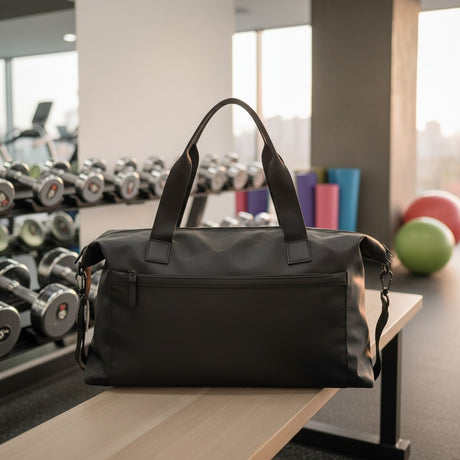 Black weekender gym bag with front zip pocket and shoulder strap
