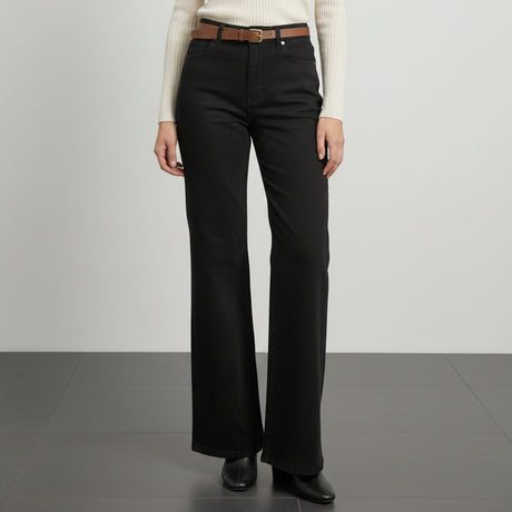 Person wearing black wide-leg pants with a brown belt on a white background
