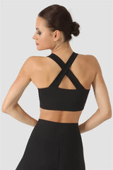 Woman wearing a black sports bra and leggings on a white background