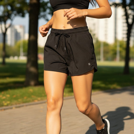 Person running wearing black active shorts outdoors on a path