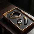 Gold and black cigar ashtray with a black and gold cutter and torch lighter in a gold edged box
