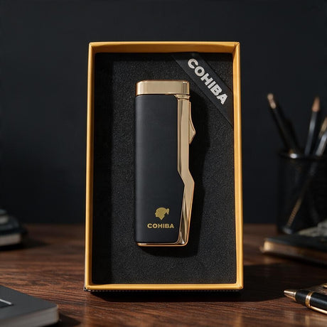 Slim matte black cigar lighter with a polished gold top and side in a gold edged box