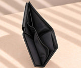 Upright black leather wallet opened slightly to show its inner pockets