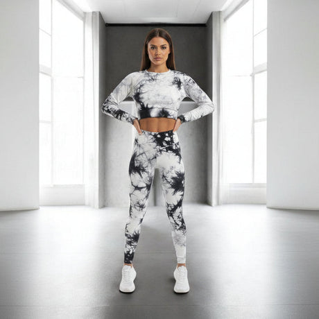 Woman wearing a black and white tie-dye athletic outfit in a minimalistic room