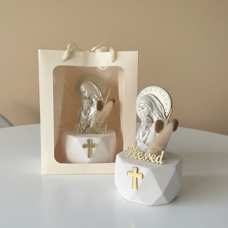 Veiled Virgin and infant relief beside a window gift bag and dried bunny tail grass