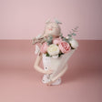 Cream bust vase with white butterflies in her hair, her paper cone full of roses