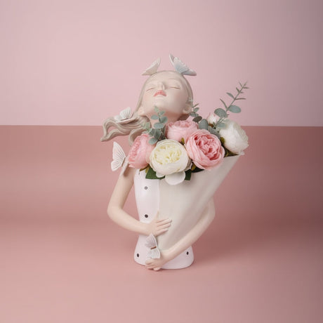Cream bust vase with white butterflies in her hair, her paper cone full of roses