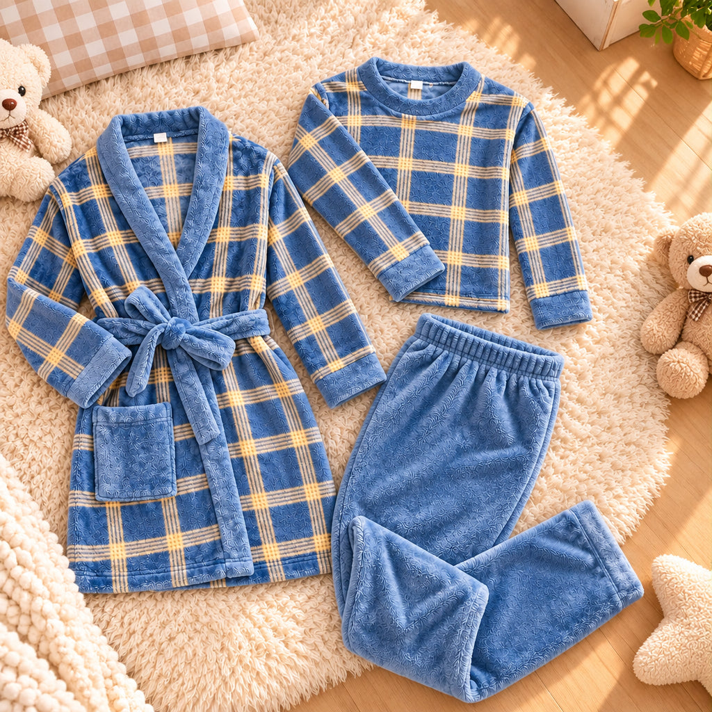 Flat lay of the blue plaid robe, plaid top and plain blue trousers on a cream rug