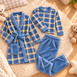 Flat lay of the blue plaid robe, plaid top and plain blue trousers on a cream rug