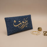 Denim blue woven long clutch wallet embroidered in gold with a cedar tree and Beirut
