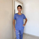Blue pyjama set with a plain top and trailing floral print on the bottoms