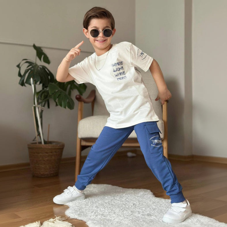 Boys set with a cream slogan print tee and blue cargo joggers, casual street style outfit