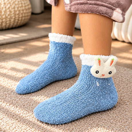 Blue fuzzy kids socks with a white cuff and a plush bunny face with carrot ears