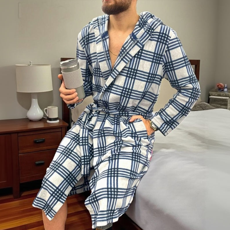 Blue checkered fleece robe worn at home while holding a travel mug