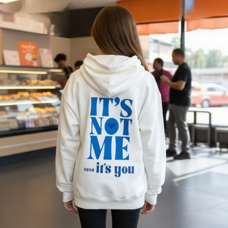 Cream oversized hoodie shown with blue joggers from the back