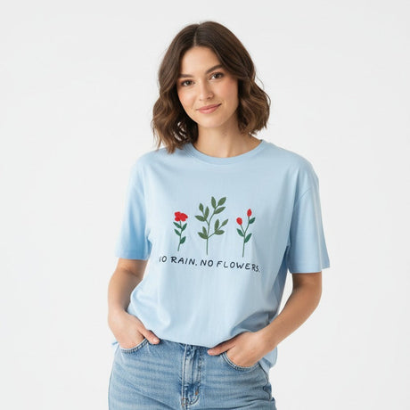 Woman wearing a blue tshirt with floral design and text on a white background