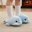 Pale blue plush slippers with a white belly and soft fins worn with tall socks