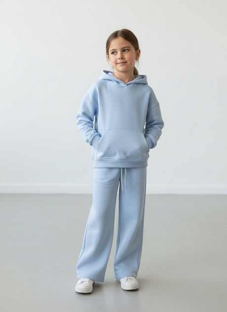 Girl in a light blue fleece hoodie and matching wide leg pants