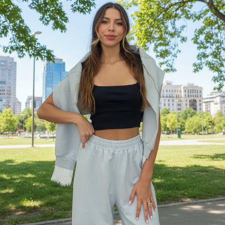 Powder blue lace trim set worn with a black top, jacket carried over the arm in a park