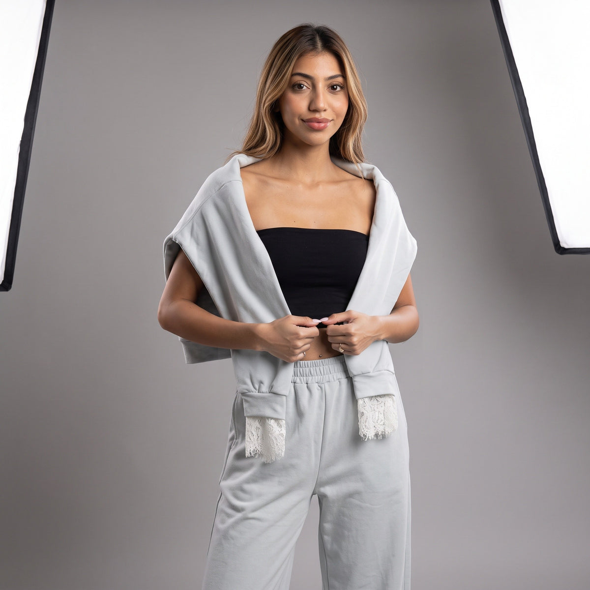 Studio shot of the powder blue set, sweatshirt held up to show the lace cuff