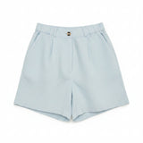 Blue linen shorts on a plain white background