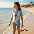 Blue mermaid print onepiece swimsuit worn on the beach with a ruffled collar