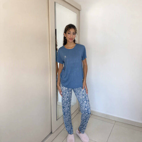 Relaxed fit blue top and patterned bottoms worn with soft pink slippers