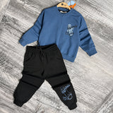 Blue skateboard sweatshirt and black joggers on a hanger