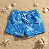 Blue starfish print boys swim shorts on the sand – Jack Gifts Online Lebanon