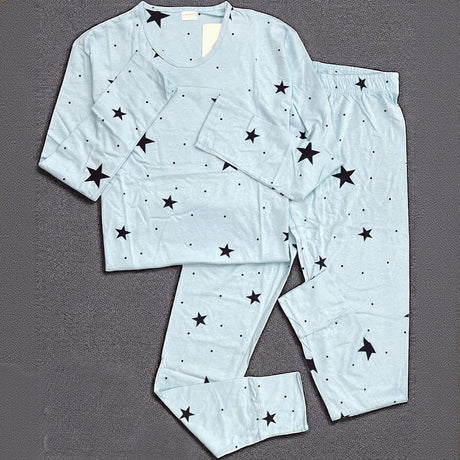 Light blue cotton pyjama set with black star print displayed on a gray background