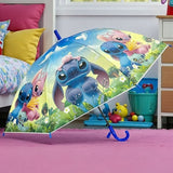 Open blue and green Stitch kids umbrella standing on a floor showing the canopy print