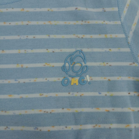 Close up of light blue stripe pyjama fabric with confetti flecks and a small outlined chest motif