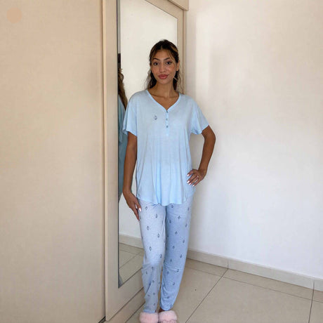 Women's pale blue henley pyjama top with a button placket and printed trousers