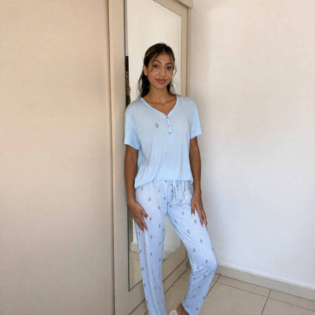 Light blue V neck sleepwear top worn with matching motif print bottoms