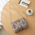 Blue and red tile tapestry crossbody bag with a long gold chain