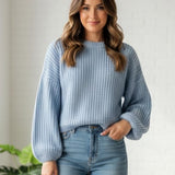Sky blue ribbed wool jumper tucked into jeans, full front view