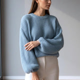 Pastel blue chunky knit jumper, puff sleeves gathered at the cuff, side angle