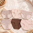Six blush and brown briefs in gingham, leopard, zebra and polka dot prints on a white bed