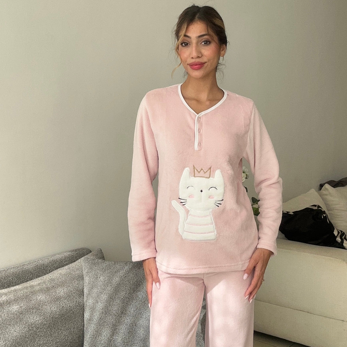 Blush pink pyjama top shown from the front with the cat applique at the waist