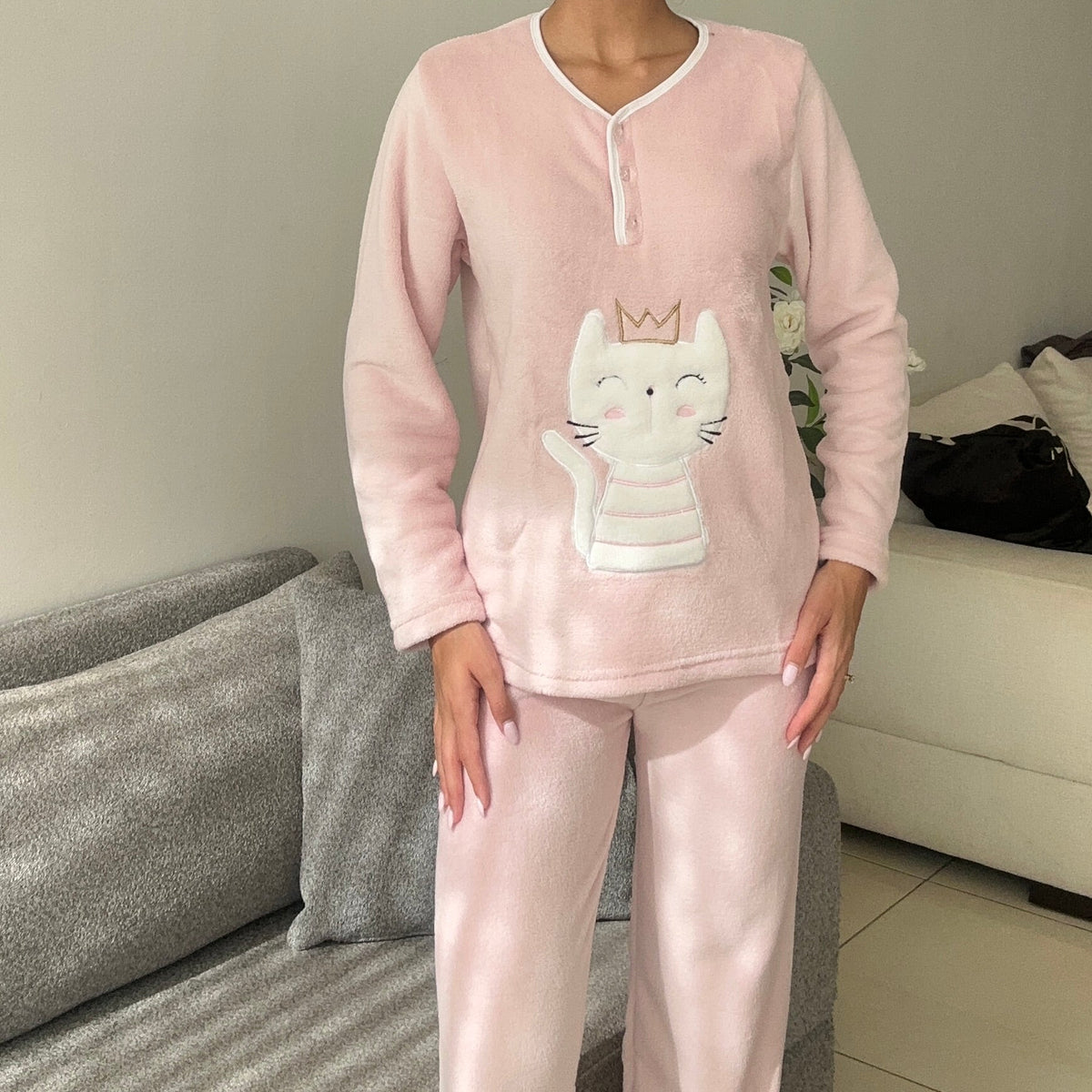 Blush pink fleece pyjama set with a white crown cat applique and piped button neck