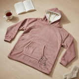 Blush pink hooded blanket laid flat showing the sherpa hood, front pocket and bear motif
