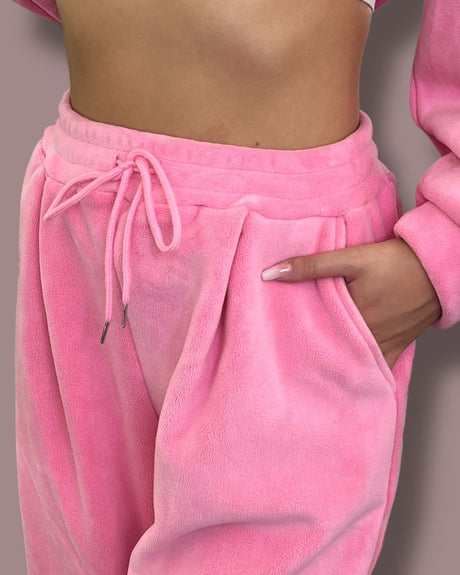 Close-up of pink fleece pants with a neutral background