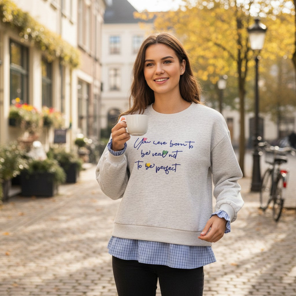 Autumn street stroll in a pale grey embroidered top with its check hem showing