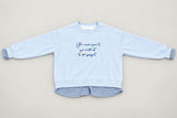 Powder blue sweatshirt flat lay showing the gingham shirt tail and frilled cuffs