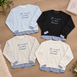 Four slogan sweatshirts in light blue, black, grey and cream with gingham shirt hems
