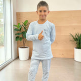 Boys light blue sleepwear top with a sailboat motif and fine stripe bottoms