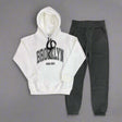 White hoodie with Brooklyn Vibes Only print laid out with charcoal joggers