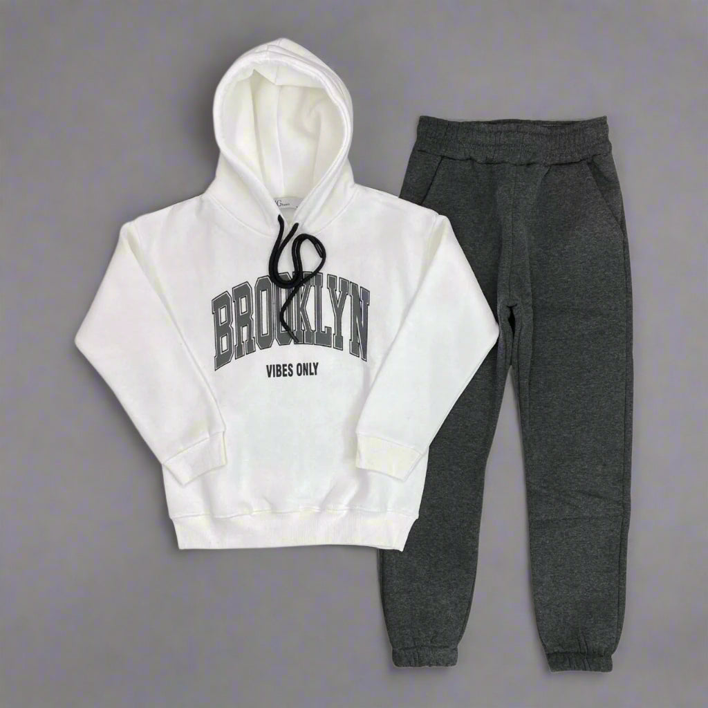 White hoodie with Brooklyn Vibes Only print laid out with charcoal joggers